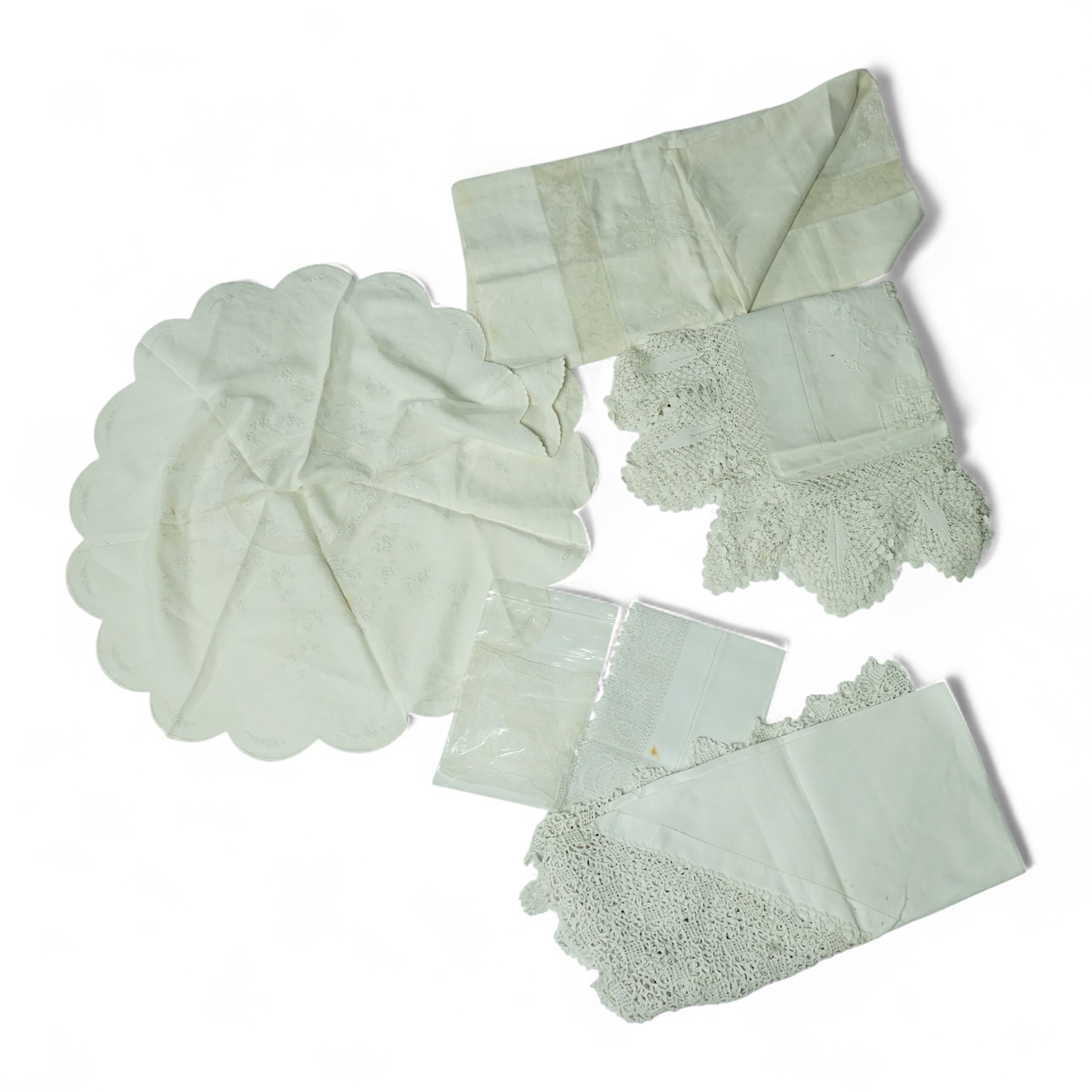 An unusual Victorian white linen hand worked table cloth. Embroidered along one edge, Wrought by L. Grover for her daughter Ethel Frances Burbury 1895. Together with three crochet edged cloths and a circular embroidered